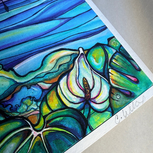 Colorful abstract painting of a flower with a signature on a gray surface